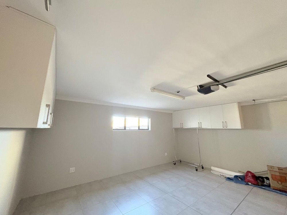 Double garage with built in cupboards for extra storage.