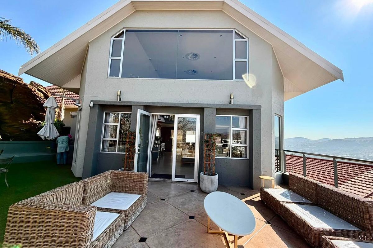 A spacious rear patio featuring tiled flooring, glass sliding doors, and an elevated view, providing a seamless transition between indoor and outdoor living spaces.