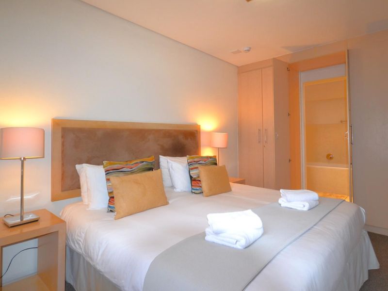 A well-maintained bedroom featuring built-in cupboards and direct access to an en-suite bathroom.