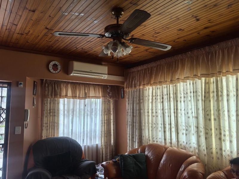 Living room featuring a timber-clad ceiling, ceiling fan, and wall-mounted split-system air conditioner.