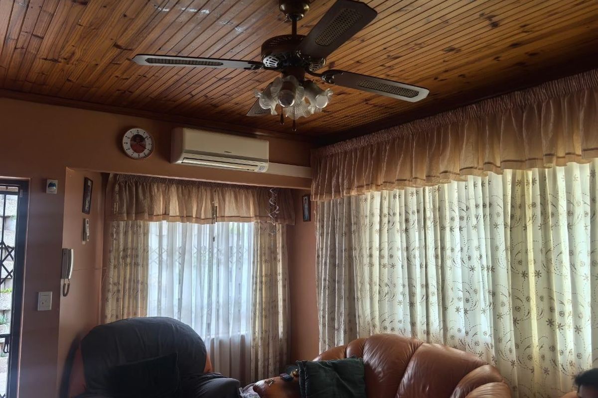Living room featuring a timber-clad ceiling, ceiling fan, and wall-mounted split-system air conditioner.