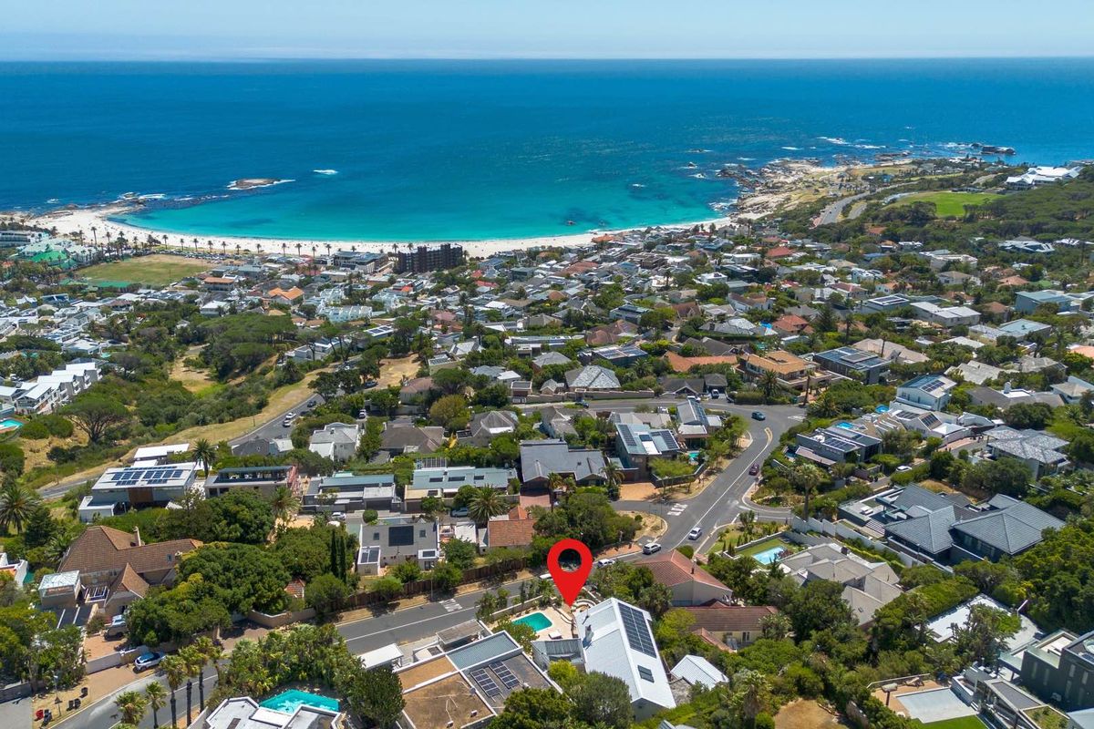 Aerial view of the property highlighting its coastal location, proximity to the beach, and surrounding residential neighborhood.