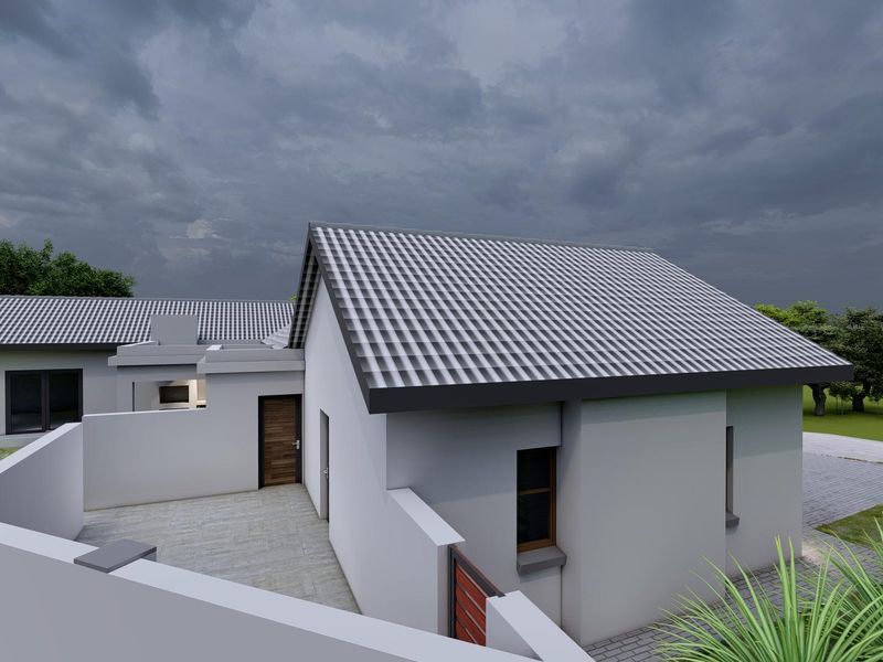 A rear view of the property featuring a tiled roof, paved patio area, and secure boundary walls.