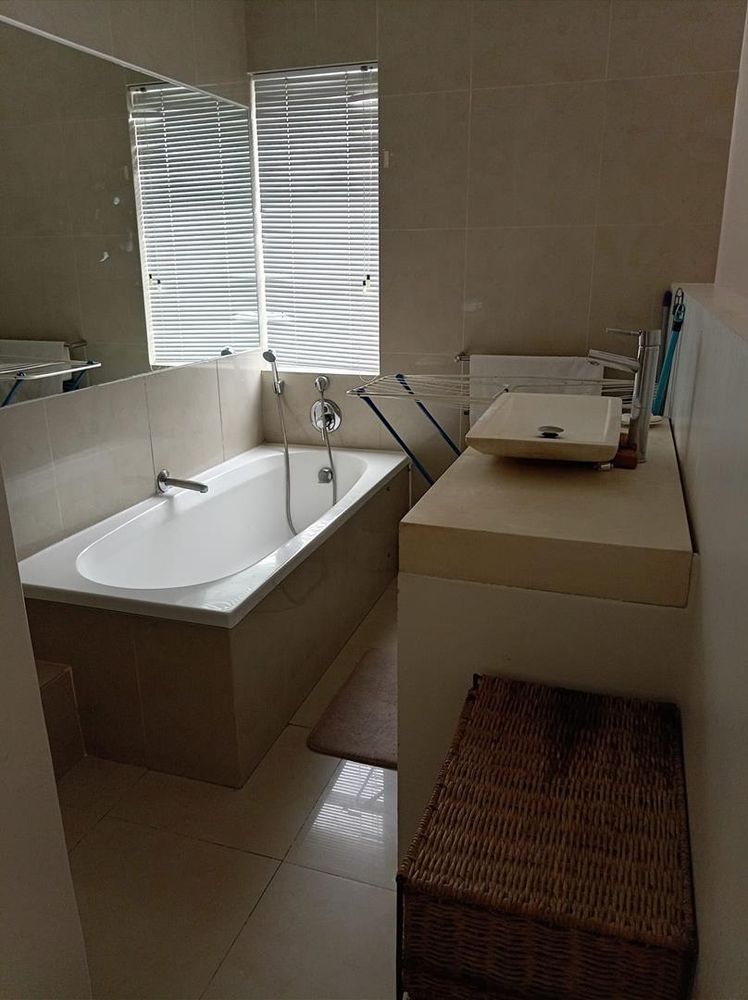 Open ensuite with bath and hand shower cable