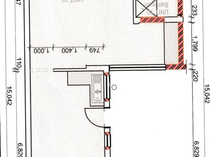 Architectural floor plan for Unit 10, showing the layout of the bedroom, bathroom, and open-plan living and kitchen area.