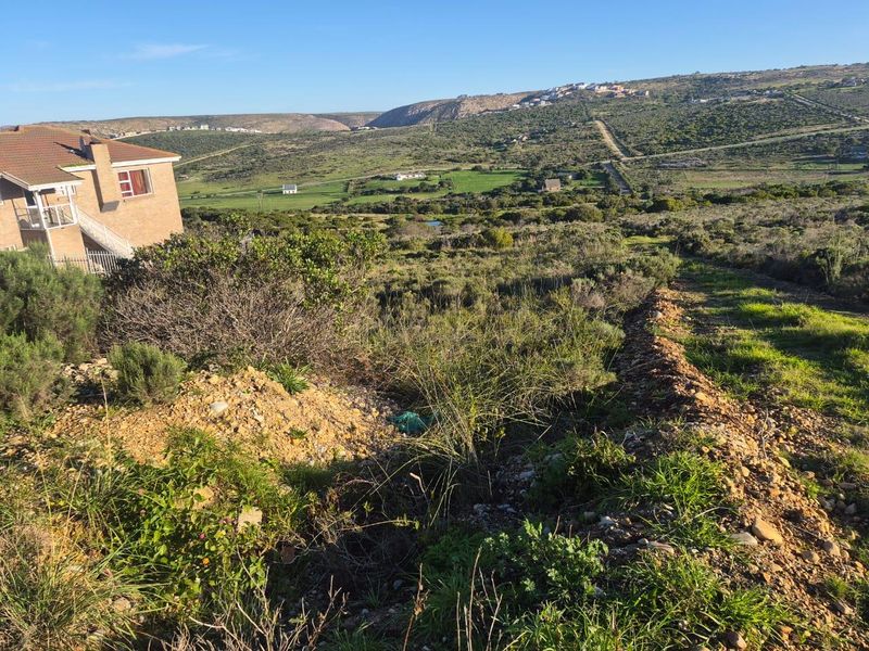 A scenic view overlooking the natural landscape and surrounding hills from the vacant residential property.