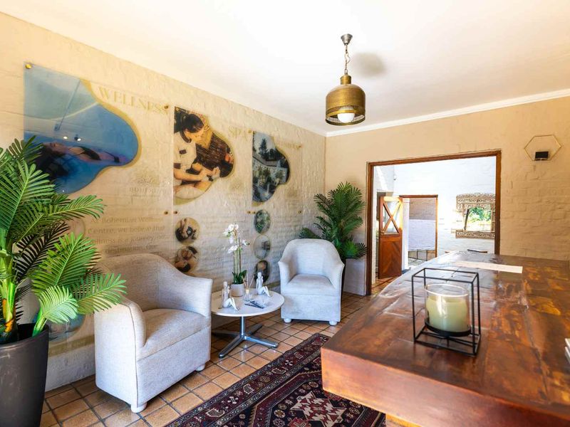 A reception or waiting area featuring textured masonry walls, tiled flooring, and a decorative pendant light fixture.