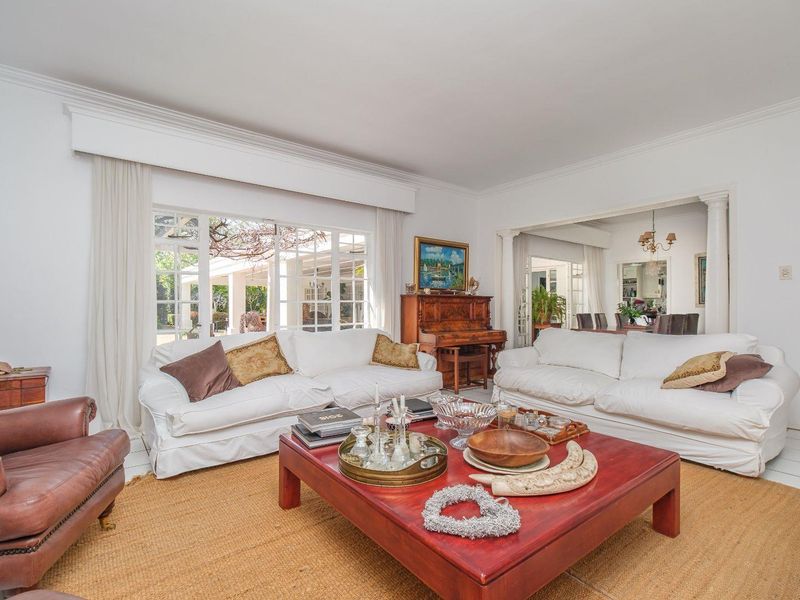 Spacious living room featuring large glass sliding doors that provide natural light and access to the outdoor patio area.