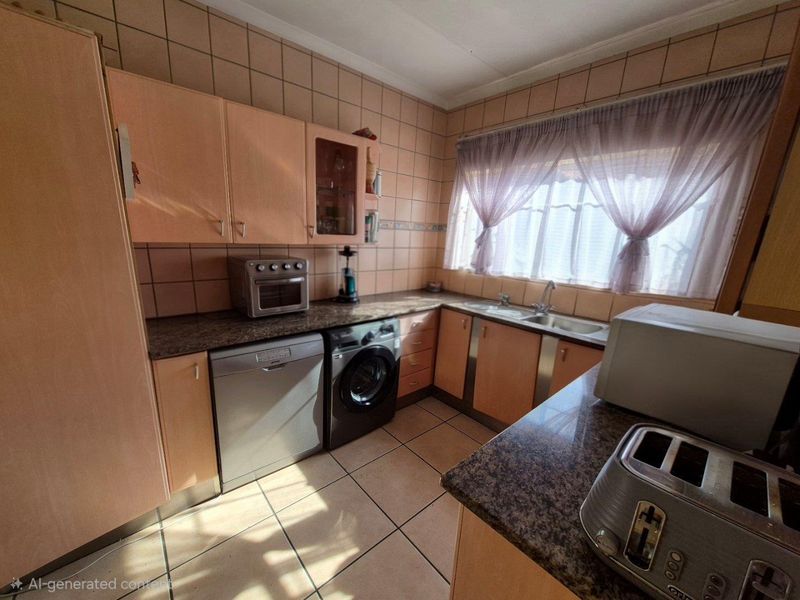 A functional kitchen featuring laminate cabinetry, granite countertops, and tiled finishes, offering a practical layout with integrated appliance spaces.