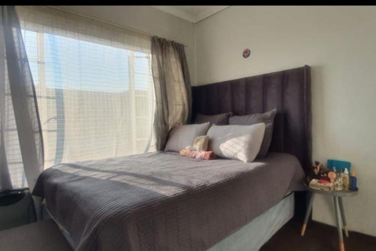 A bedroom featuring a large window that allows for natural light, providing a bright and airy atmosphere.