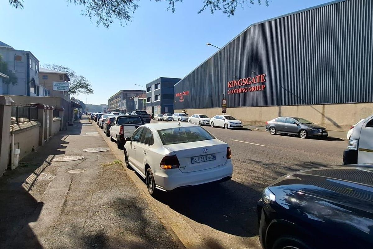 Street view showing the industrial exterior facade of the property with adjacent sidewalk and road access.