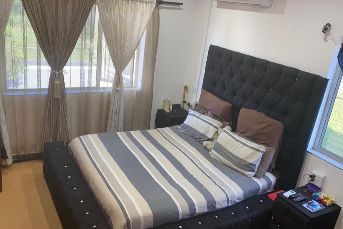 A bedroom featuring an air conditioning unit and large windows providing natural light.