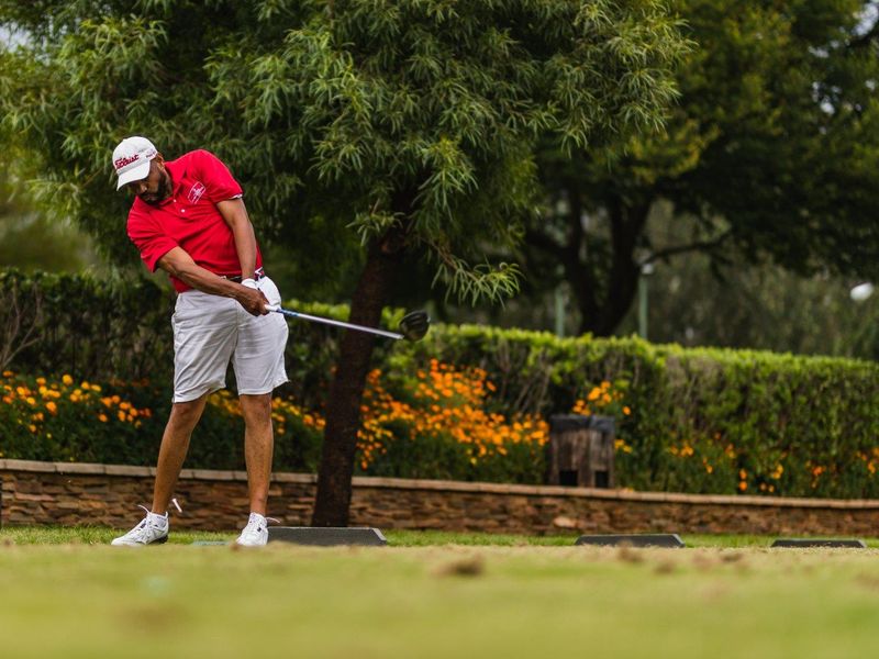 A person playing golf on a landscaped course, which does not provide relevant information about the residential property assets.