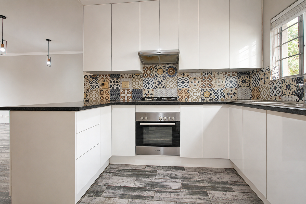 Modern kitchen featuring white cabinetry, granite countertops, a patterned tile backsplash, stainless steel oven, gas hob, and wood-look tile flooring.