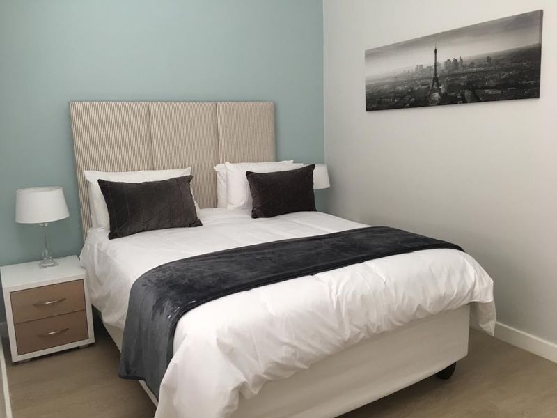 A well-maintained bedroom featuring neutral wall tones and light-colored flooring, providing a clean and comfortable living space.
