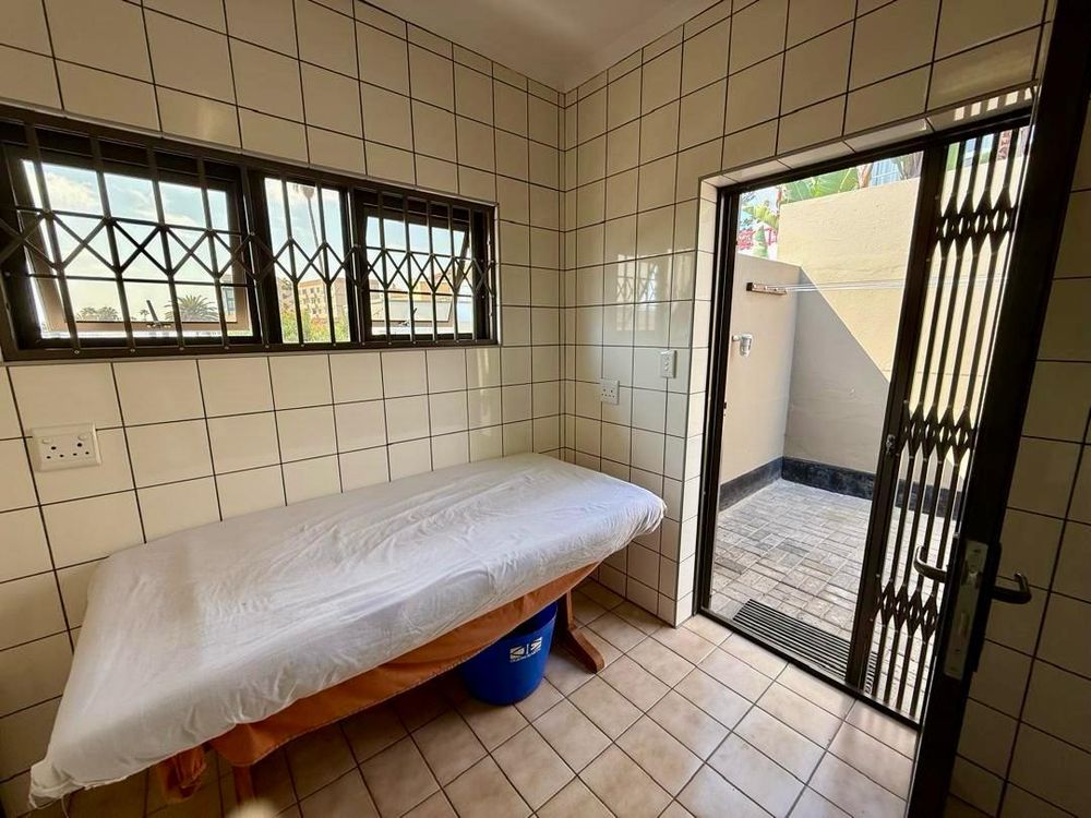 Laundry room behind walk-in closet