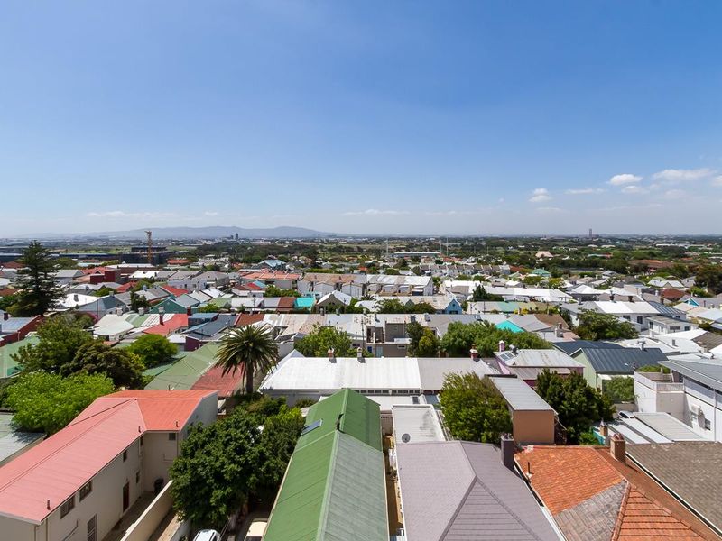 An elevated panoramic view overlooking the surrounding residential neighborhood and urban landscape under a clear blue sky.