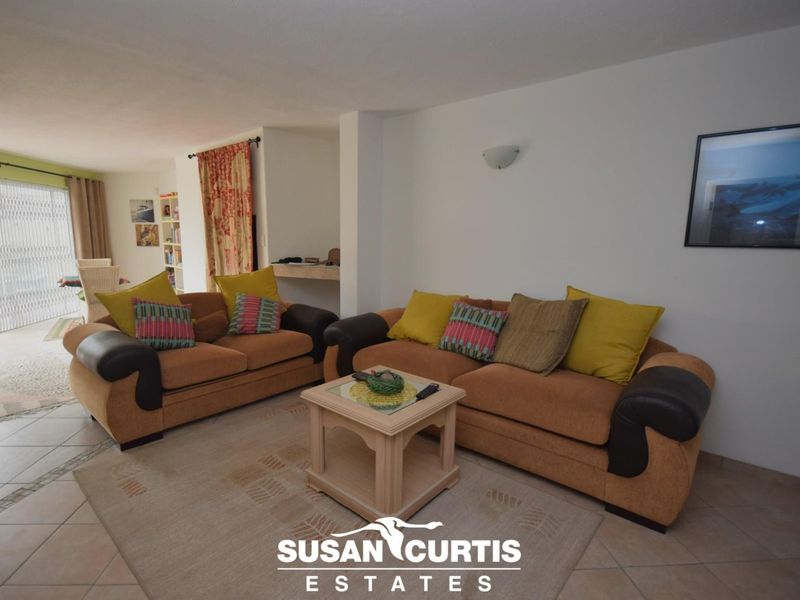 Open plan living area featuring tiled flooring and access to an outdoor patio through sliding glass doors.