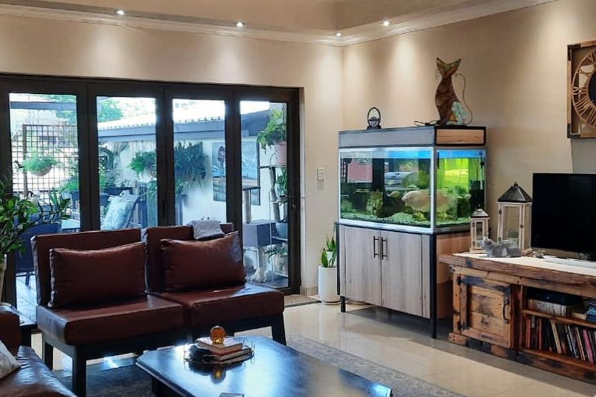 Spacious living room featuring large bi-fold doors that open onto an outdoor patio area, creating a seamless indoor-outdoor flow.