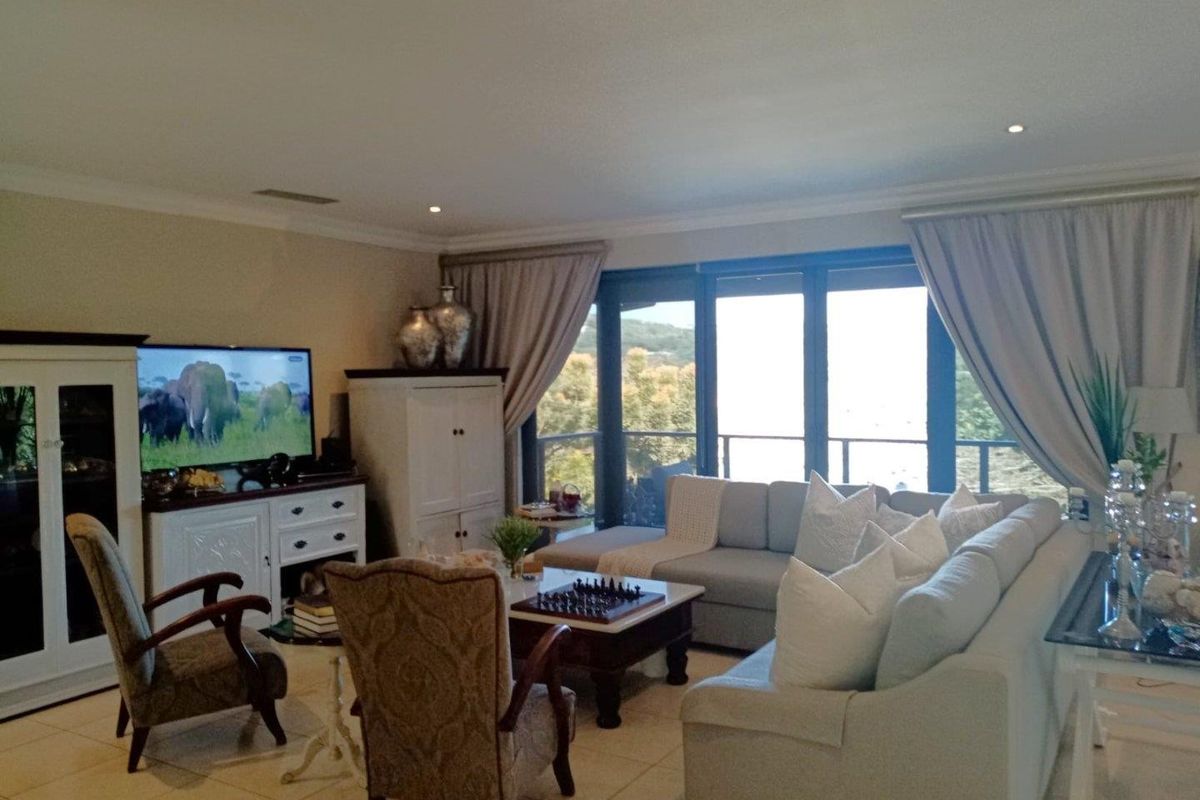 Spacious living room featuring tiled flooring, recessed downlighting, and large sliding glass doors that provide natural light and access to the outdoor area.