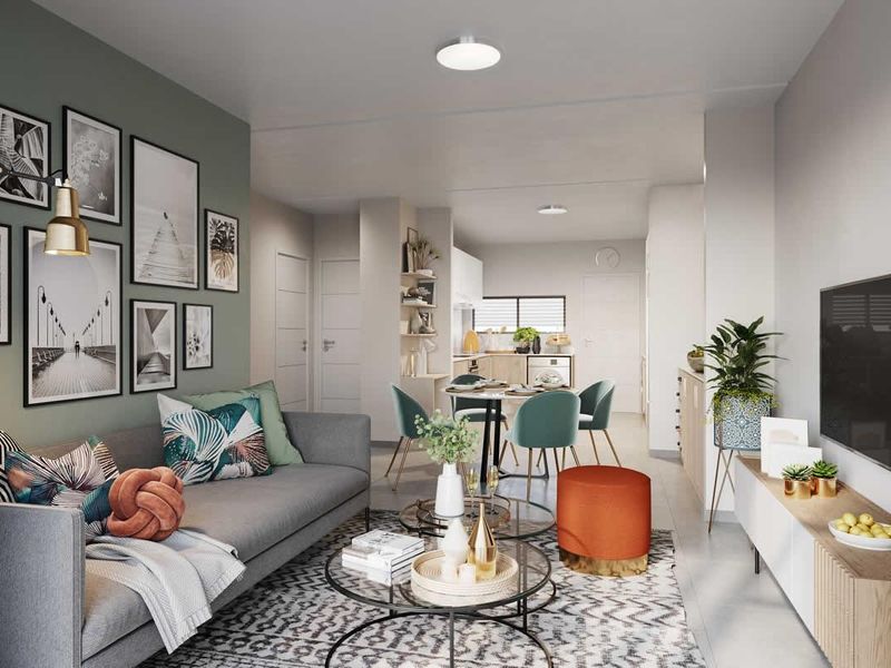 Modern open-plan living and dining area featuring neutral tones, tiled flooring, and a seamless transition into a functional kitchen space.
