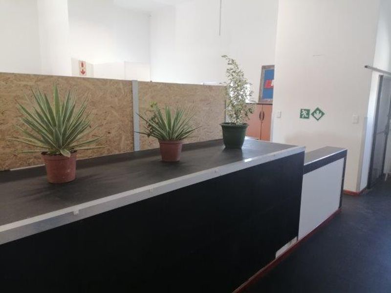 A functional office reception area featuring a built-in desk and partition wall, providing a clean and professional workspace layout.