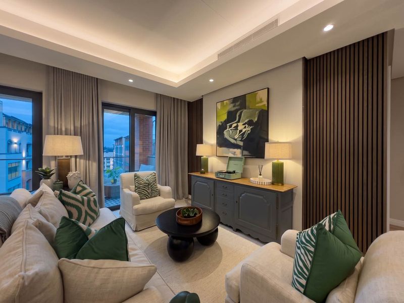 A modern, well-lit living room featuring elegant timber slat wall paneling, recessed ceiling lighting, and direct access to a private balcony.