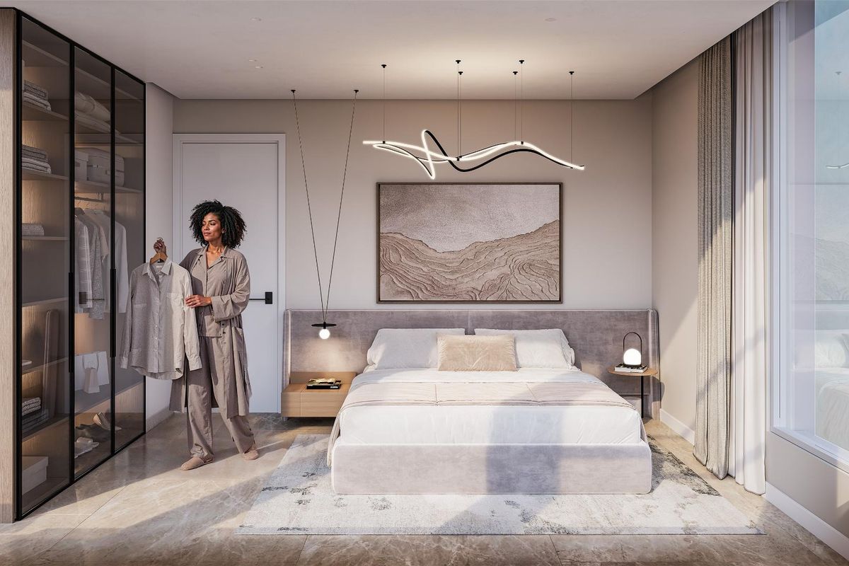 Modern bedroom featuring a floor-to-ceiling glass wardrobe, custom upholstered headboard, and contemporary designer pendant lighting in a high-end penthouse setting.