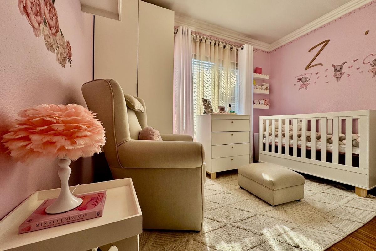 A well-maintained bedroom featuring built-in cabinetry, crown molding, and large windows that provide ample natural light.
