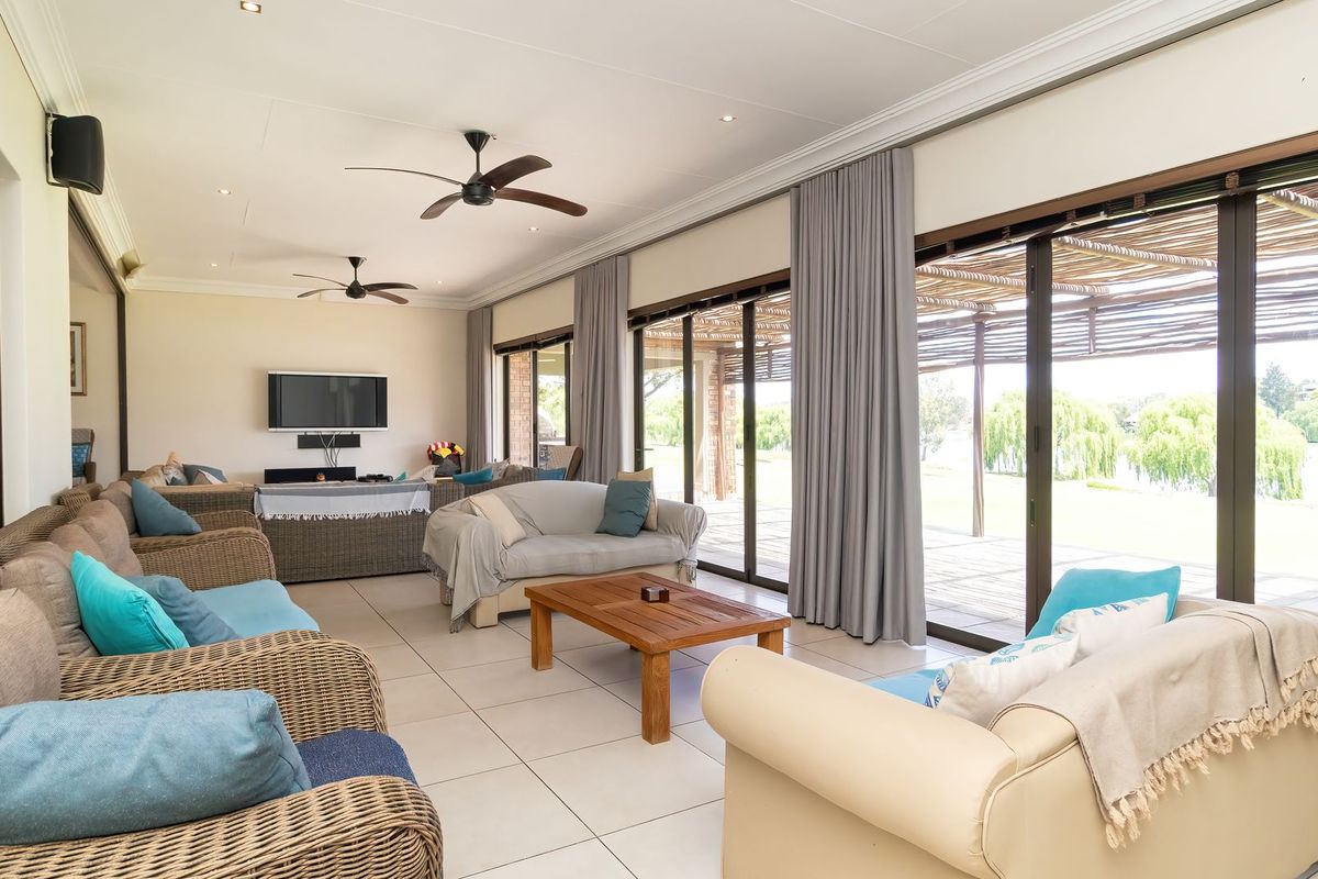 Spacious living area featuring large sliding glass doors that provide abundant natural light and seamless access to the outdoor patio and garden views.