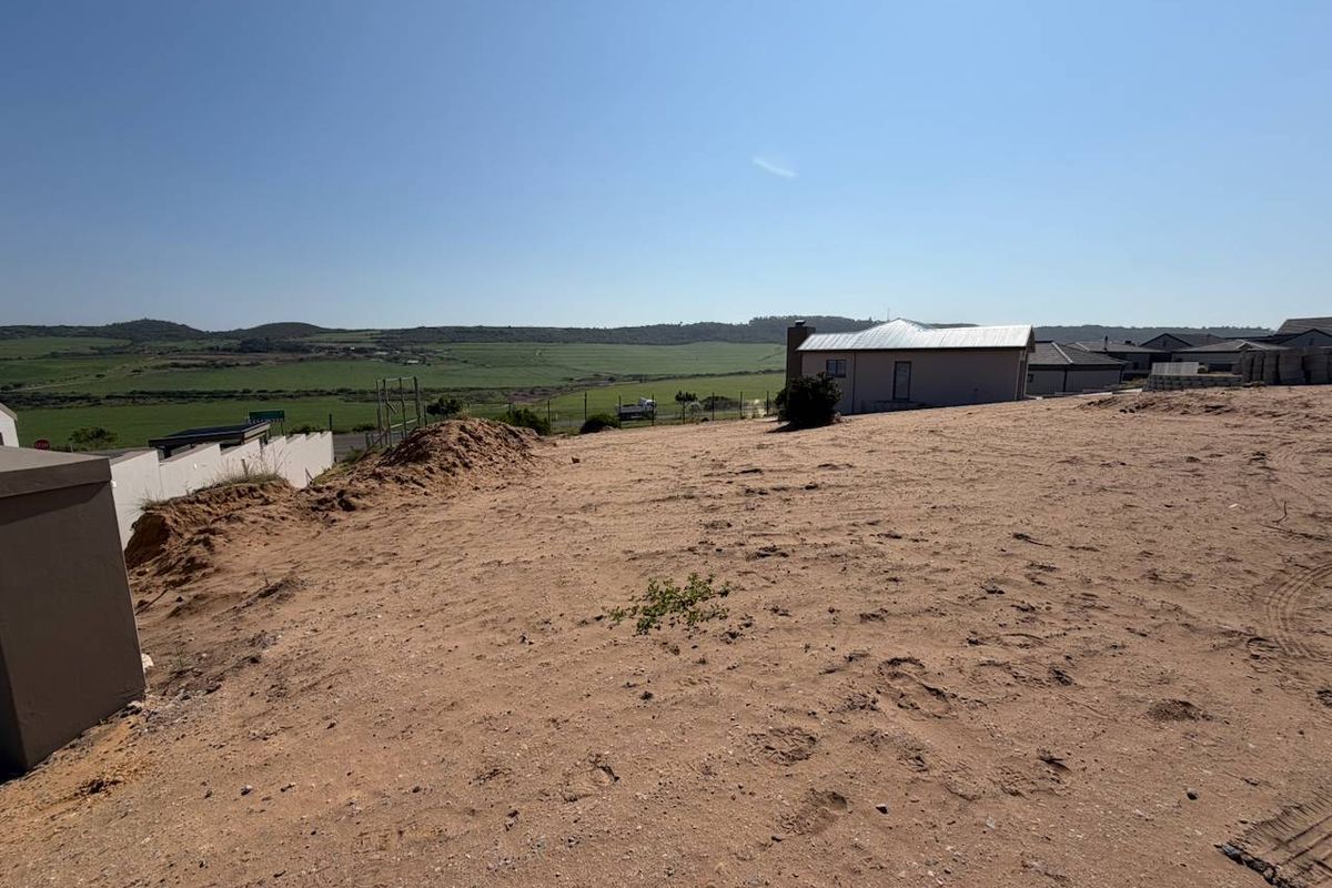 A view of the vacant residential land plot featuring a gentle slope and surrounding landscape views.