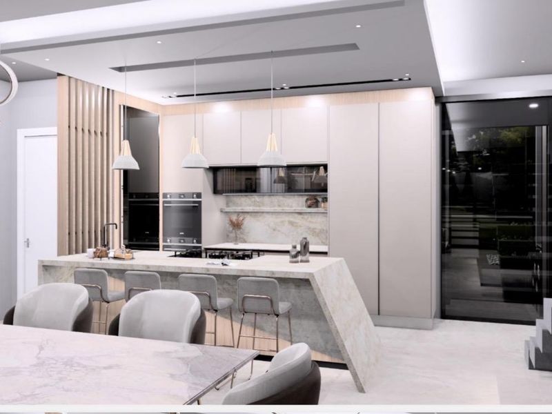 Modern open-plan kitchen featuring a stone waterfall island, integrated cabinetry, built-in appliances, and sophisticated recessed ceiling lighting in a contemporary design.