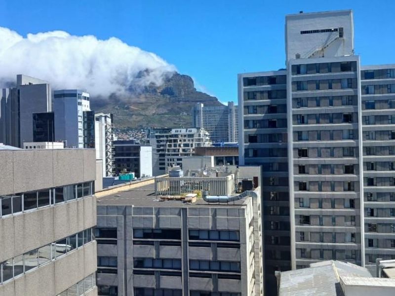 Elevated urban view overlooking the city skyline with Table Mountain in the background.