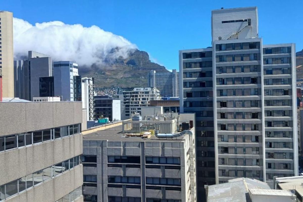 Elevated urban view overlooking the city skyline with Table Mountain in the background.