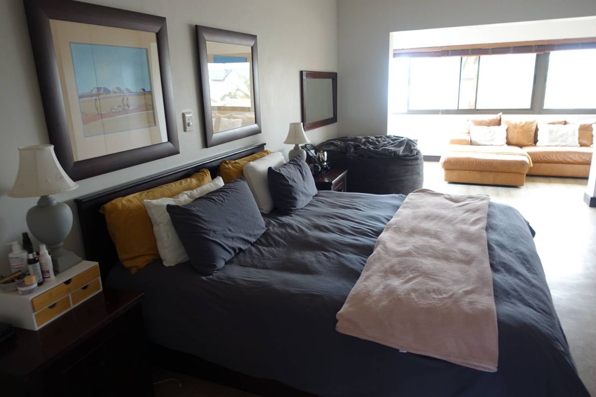 A spacious bedroom featuring large windows that provide ample natural light and a comfortable layout.