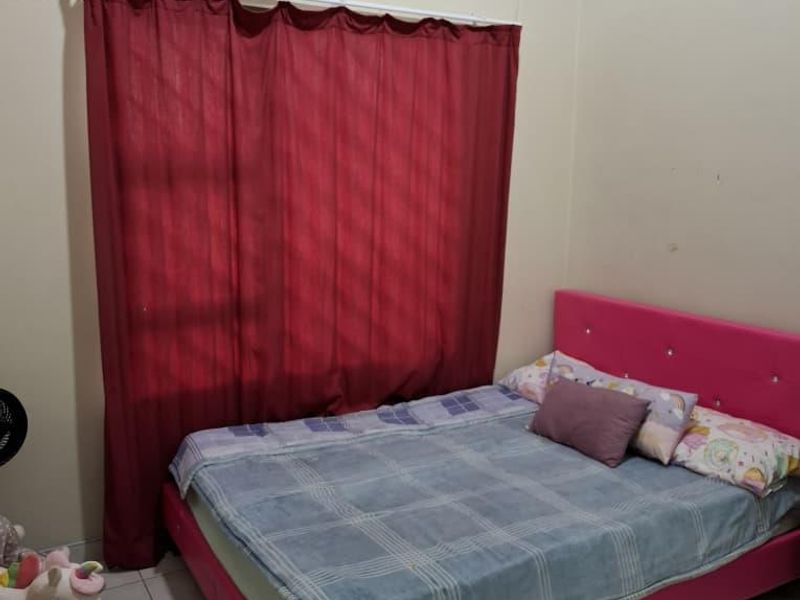 A functional bedroom featuring tiled flooring and a window with a curtain rod, providing a simple and practical living space.