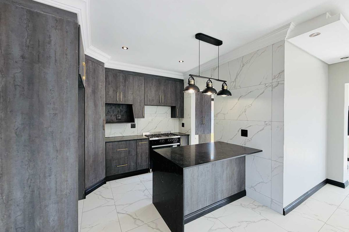 Modern kitchen featuring dark textured cabinetry, a central island, gas hob, marble-look wall tiles, and high-quality porcelain flooring with recessed and pendant lighting.