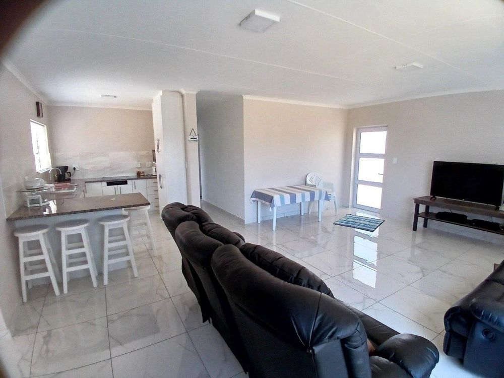 Same SPACIOUS Living Area; Kitchen on our left with front door on our  far right.