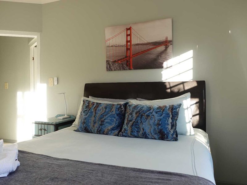 A well-maintained bedroom featuring neutral wall tones and natural light, providing a comfortable and inviting sleeping space.