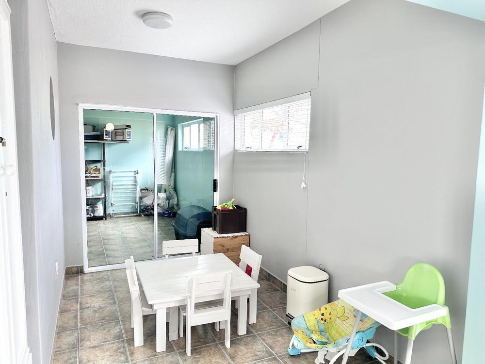 Living area, kiddies room leading to garage storage with sliding doors