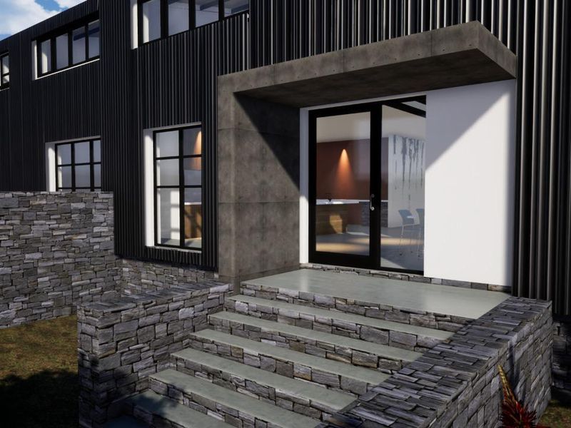 Modern architectural front entrance featuring stone retaining walls, concrete steps, and dark metal cladding with a glass entry door.