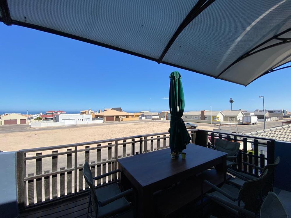 First-floor balcony with distant sea view