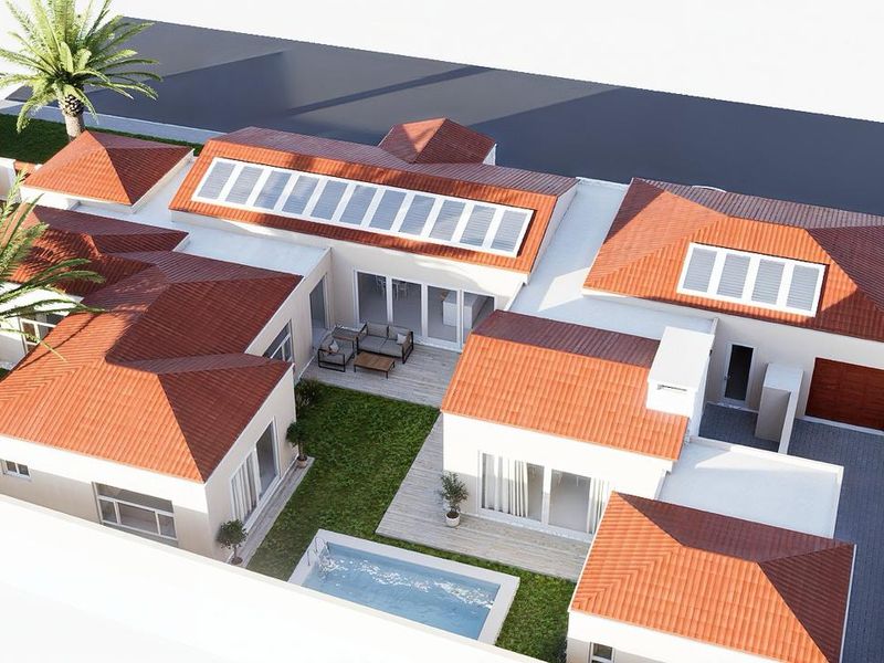 Aerial view of a modern residential property featuring a tiled roof with solar panels, a central courtyard with a swimming pool, and paved driveway.