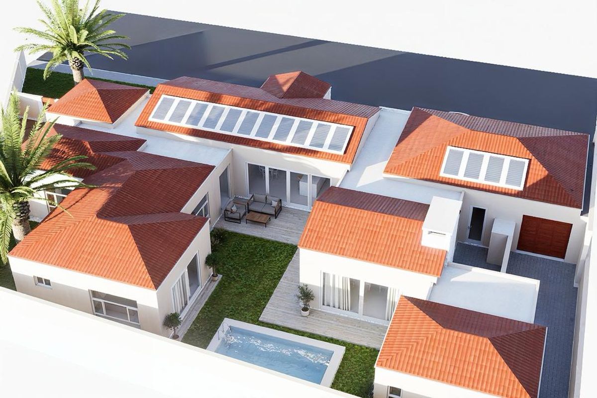 Aerial view of a modern residential property featuring a tiled roof with solar panels, a central courtyard with a swimming pool, and paved driveway.