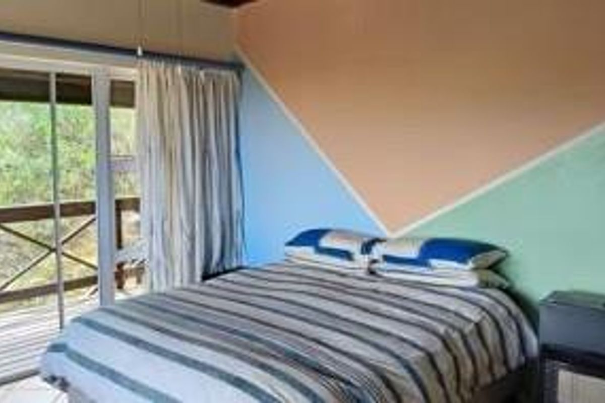 A bedroom featuring sliding glass doors that provide direct access to an outdoor balcony area.