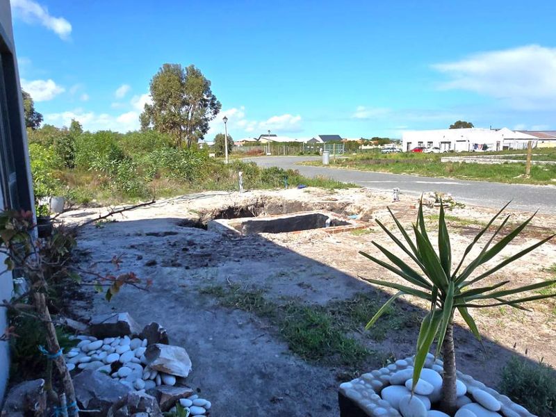 Rear yard area featuring an unfinished pool shell and exposed ground, requiring significant landscaping and completion of the pool structure.