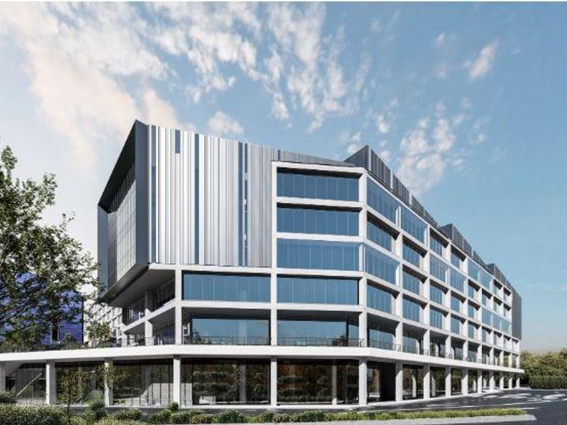 Modern multi-story office building featuring a contemporary concrete frame, extensive glass curtain walling, and sleek metal cladding elements.