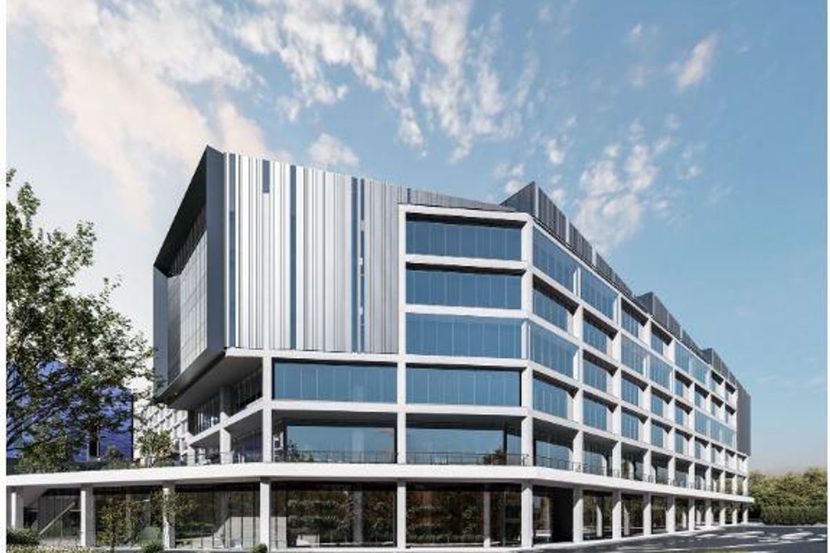Modern multi-story office building featuring a contemporary concrete frame, extensive glass curtain walling, and sleek metal cladding elements.