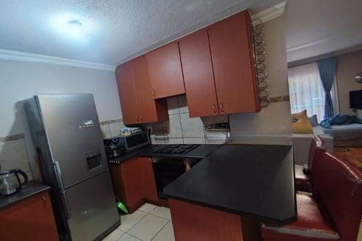 A functional kitchen featuring built-in cabinetry, a breakfast nook, and integrated cooking appliances, offering a practical layout for daily meal preparation.