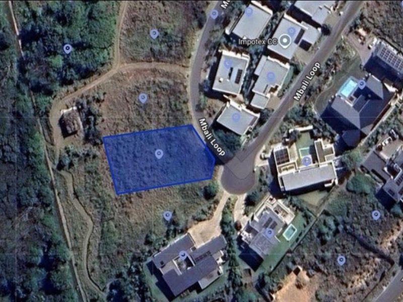 Aerial view of a vacant residential land plot located on Mbali Loop, showing the site boundaries and surrounding neighborhood context.